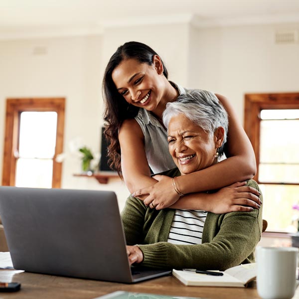 mother and daughter using laptop